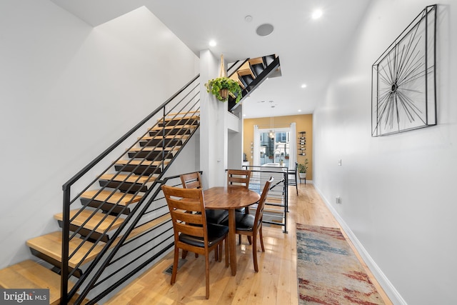 dining room with an inviting chandelier and light hardwood / wood-style flooring