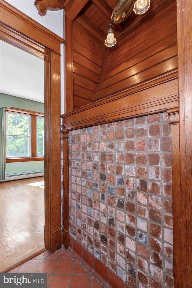 details featuring a baseboard radiator and wood walls