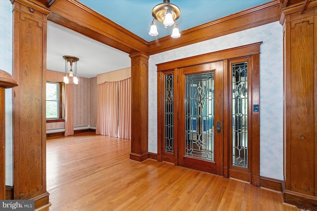 entrance foyer with light wood-type flooring, decorative columns, baseboards, and a baseboard radiator