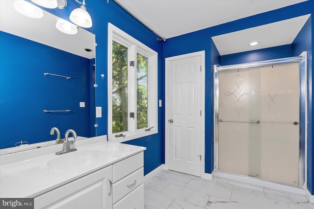 bathroom featuring baseboards, a shower stall, marble finish floor, and vanity