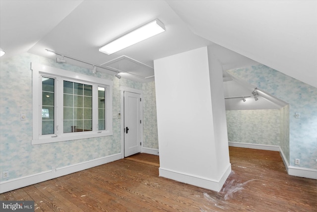 bonus room with baseboards, vaulted ceiling, hardwood / wood-style flooring, and wallpapered walls