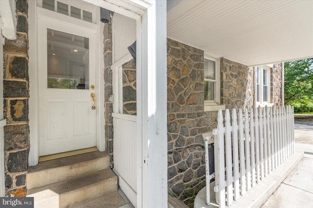 entrance to property featuring stone siding