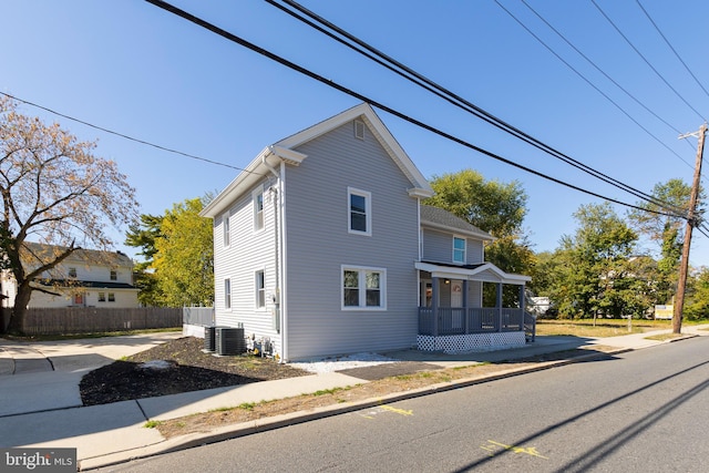 view of front of property with a porch and central AC