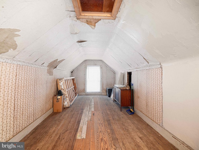 bonus room featuring vaulted ceiling and light hardwood / wood-style flooring