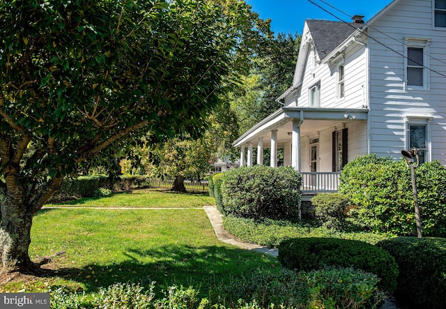 view of yard featuring covered porch