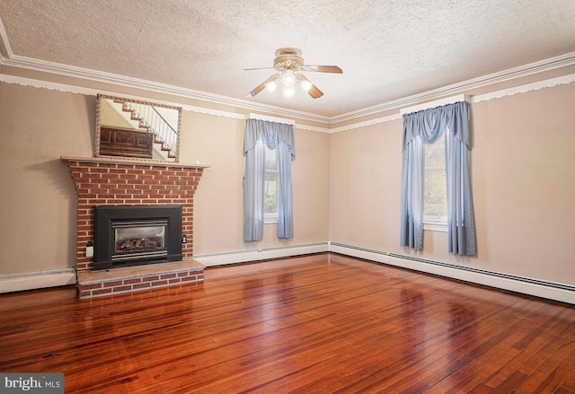 unfurnished living room with a wealth of natural light, crown molding, a textured ceiling, and hardwood / wood-style flooring