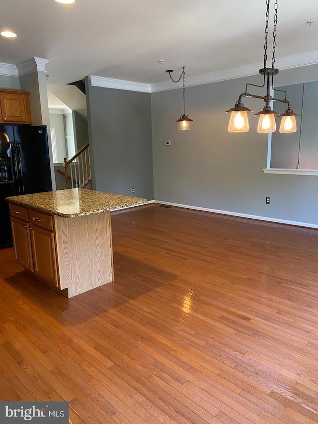 kitchen with hanging light fixtures, a kitchen island, and hardwood / wood-style floors