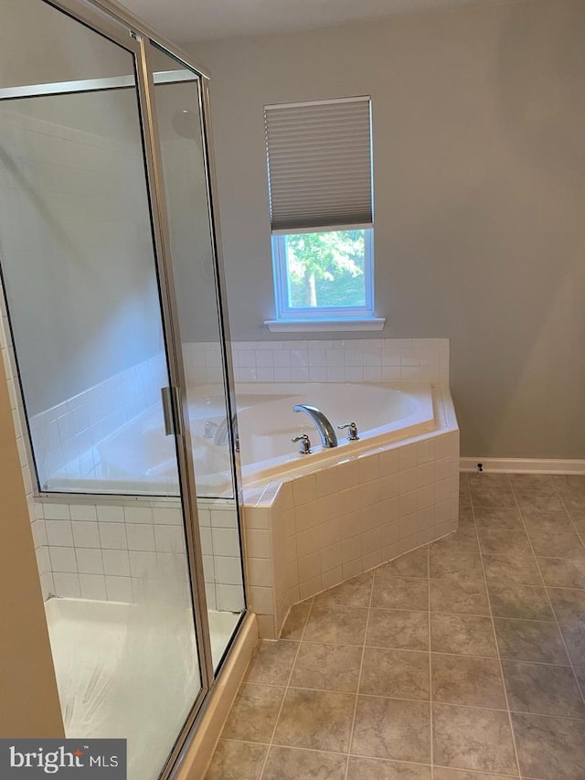 bathroom featuring independent shower and bath and tile patterned flooring