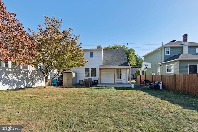 rear view of house with a yard and a patio