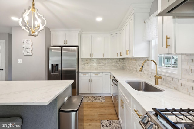 kitchen featuring light hardwood / wood-style floors, white cabinetry, stainless steel appliances, and light stone countertops