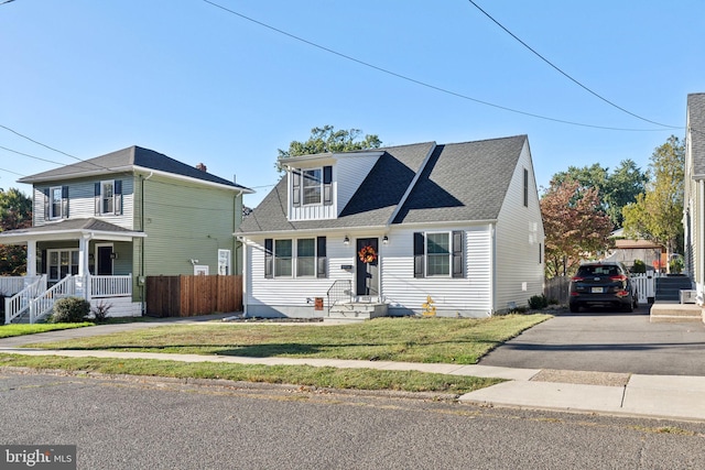 view of front of home with a front yard and covered porch