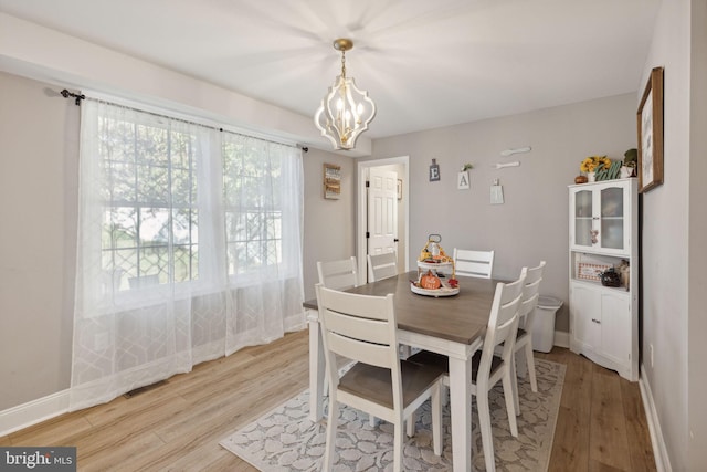 dining area featuring a chandelier and light hardwood / wood-style floors