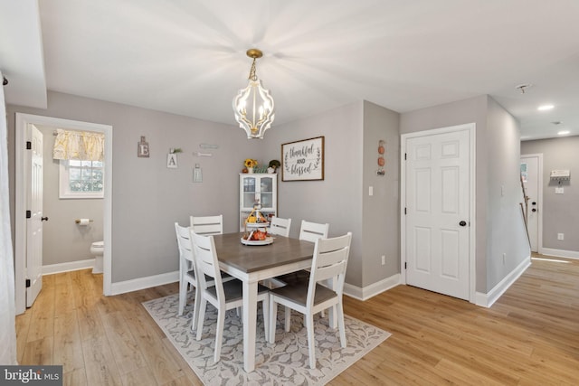 dining room with a chandelier and light hardwood / wood-style floors