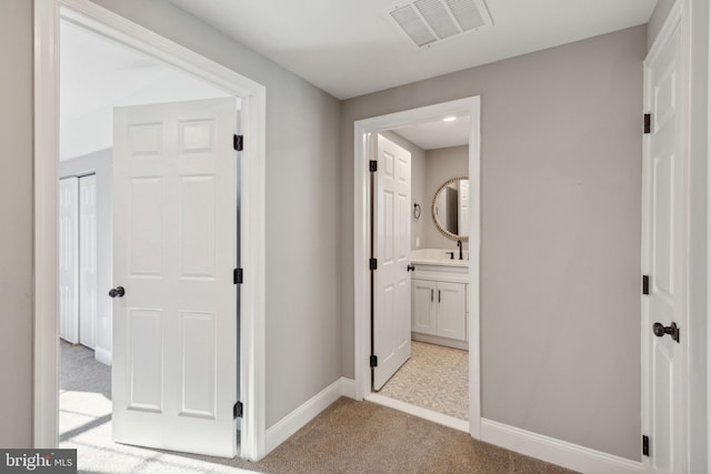 corridor with light colored carpet