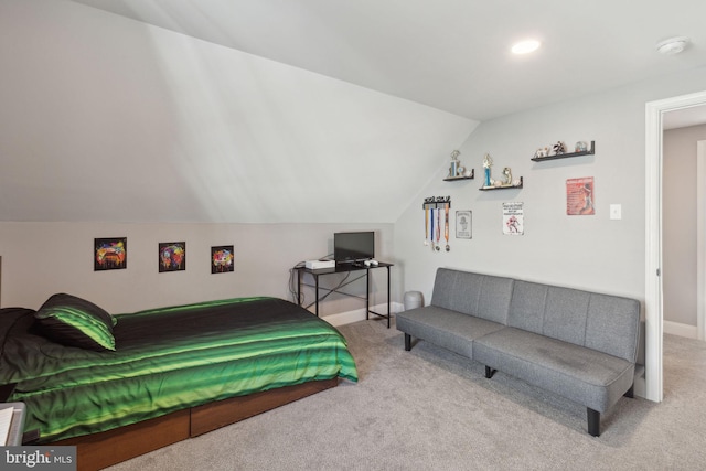 bedroom featuring lofted ceiling and carpet flooring