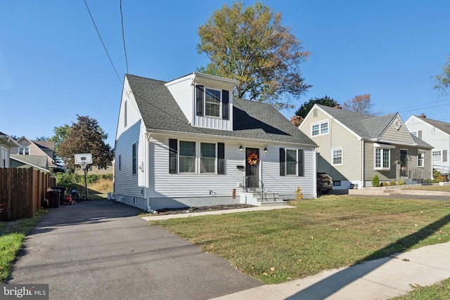 cape cod home with a front yard