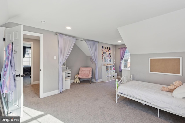 carpeted bedroom with lofted ceiling and multiple windows