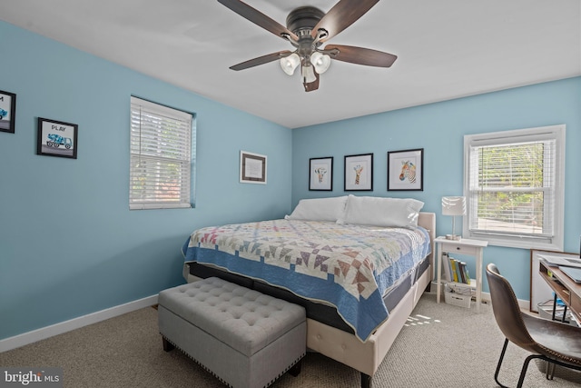 bedroom with carpet flooring, multiple windows, and baseboards