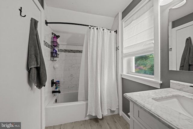 bathroom with wood finished floors, shower / bath combo, and vanity