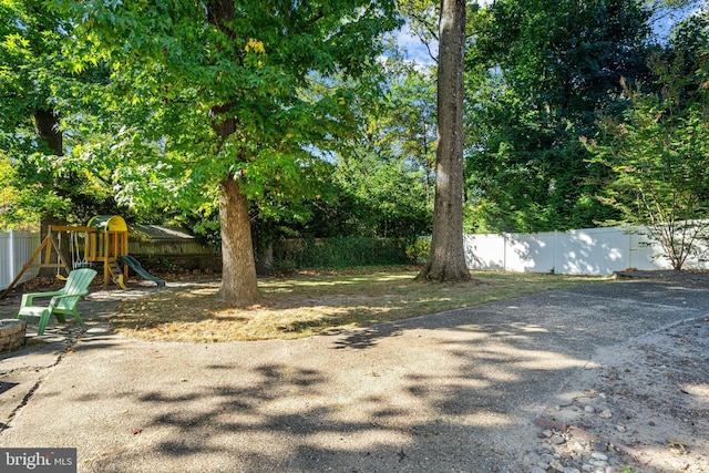 view of yard with a playground and fence