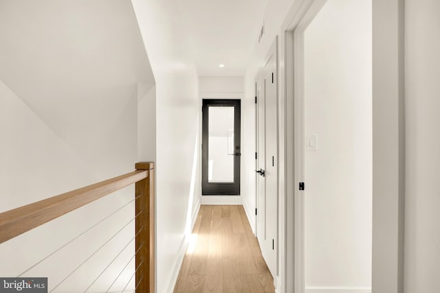 hallway with light hardwood / wood-style flooring