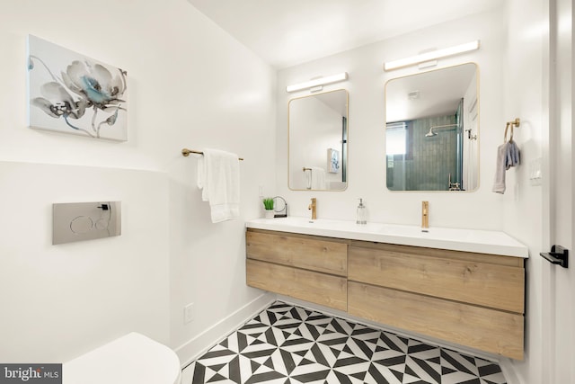 bathroom featuring vanity, toilet, tile patterned floors, and a shower