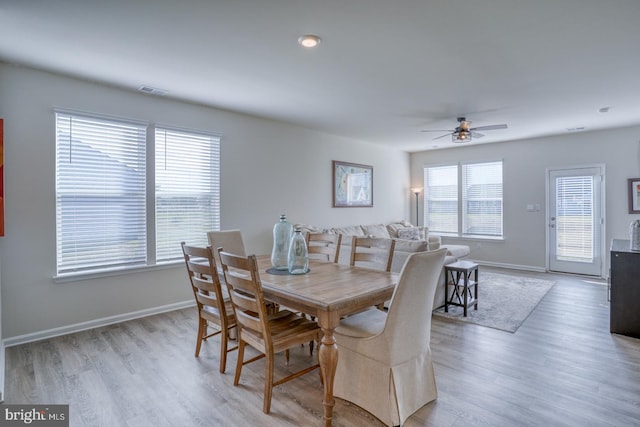 dining room with light hardwood / wood-style floors and ceiling fan