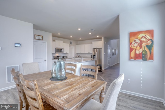 dining space featuring light hardwood / wood-style floors