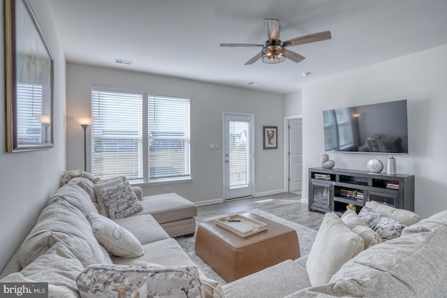 living room featuring ceiling fan and light wood-type flooring