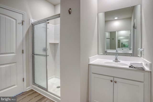 bathroom featuring vanity, hardwood / wood-style floors, and an enclosed shower