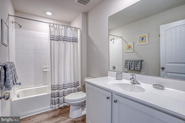 full bathroom with vanity, toilet, shower / bath combo, and hardwood / wood-style floors