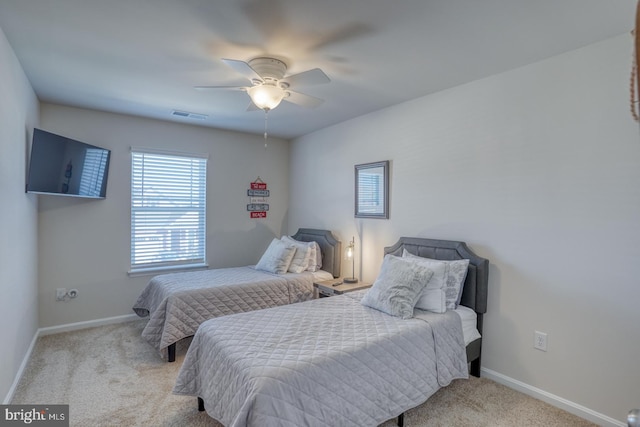 bedroom featuring light colored carpet and ceiling fan