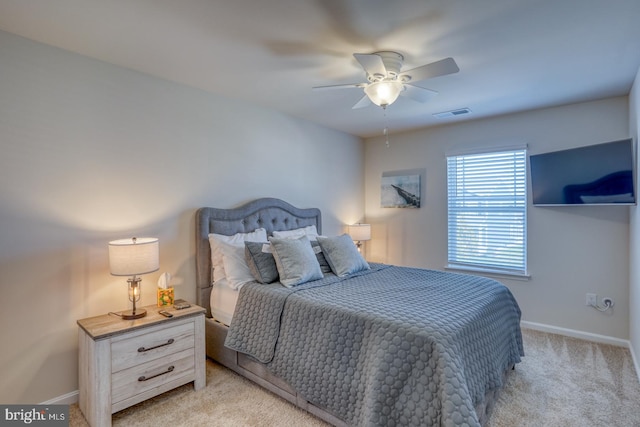 bedroom featuring light carpet and ceiling fan