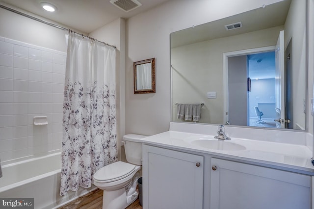 full bathroom featuring vanity, shower / bath combo with shower curtain, toilet, and wood-type flooring