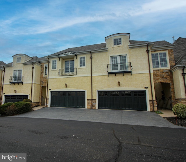 view of property featuring central AC unit and a garage