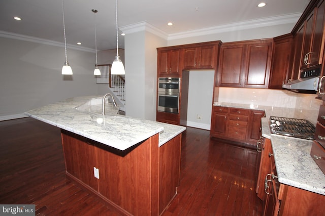 kitchen featuring a large island, decorative light fixtures, double oven, and dark hardwood / wood-style floors