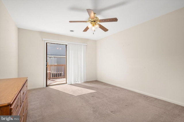 carpeted empty room featuring ceiling fan