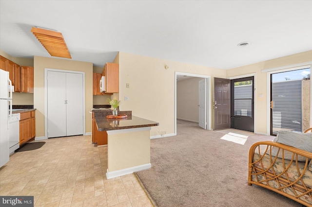 kitchen with light carpet and white appliances