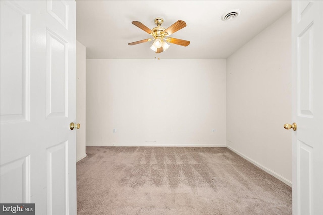 empty room with light colored carpet and ceiling fan