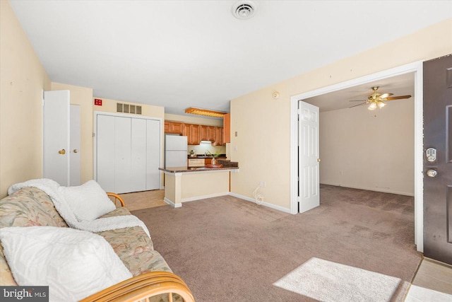 living room with ceiling fan and light colored carpet