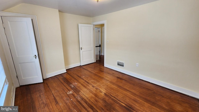 unfurnished bedroom featuring dark hardwood / wood-style floors