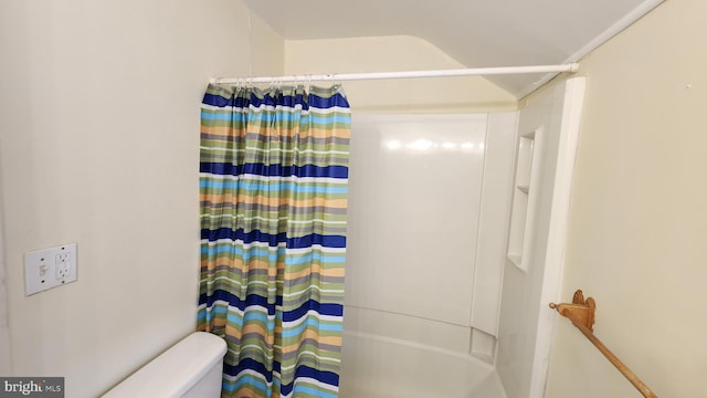 bathroom featuring vaulted ceiling and toilet