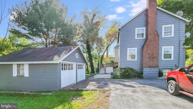 view of home's exterior featuring a garage and an outdoor structure