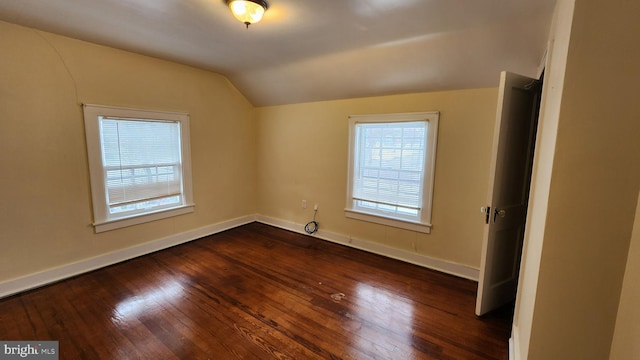 additional living space featuring lofted ceiling and dark hardwood / wood-style floors