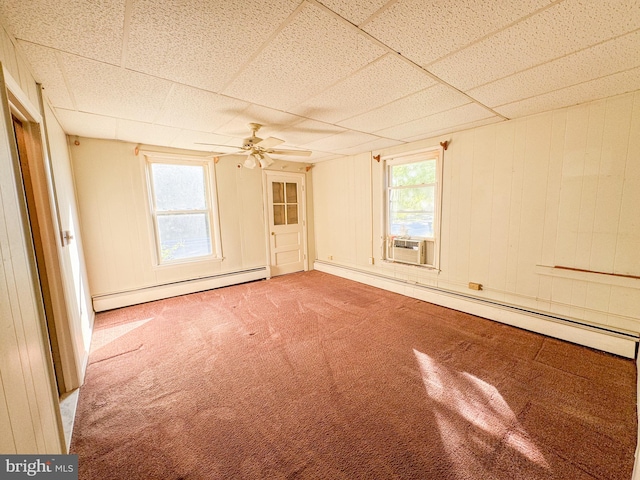 unfurnished room featuring ceiling fan, a healthy amount of sunlight, carpet flooring, and baseboard heating