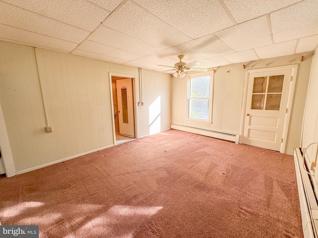 unfurnished room with a baseboard heating unit, carpet floors, and ceiling fan