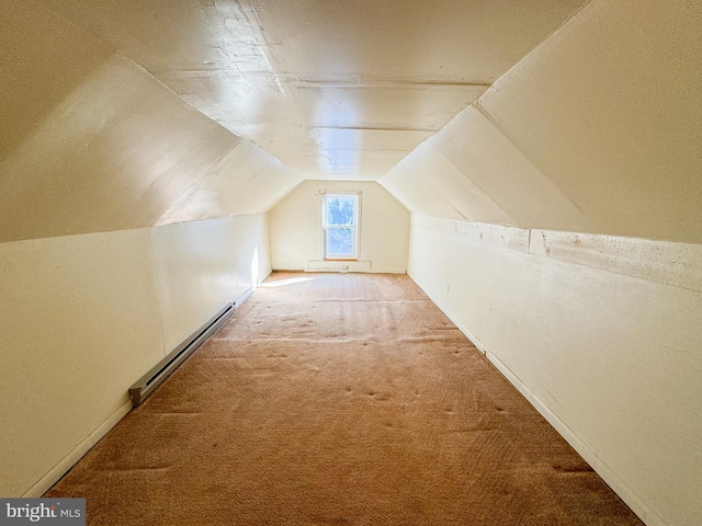 additional living space with lofted ceiling, a baseboard heating unit, and carpet flooring