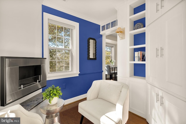 living area featuring ornamental molding and dark wood-type flooring