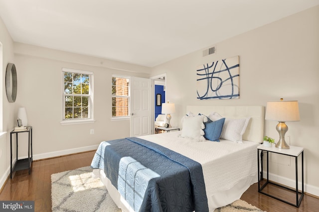 bedroom with dark wood-type flooring