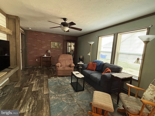 living room with brick wall, ceiling fan, a textured ceiling, and dark hardwood / wood-style flooring